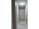 Long, bright hallway features multiple white doors and marble tile floors at 2775 Emerald Springs Dr, Lawrenceville, GA 30045