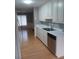 Well-maintained kitchen with wooden floors, stainless steel dishwasher, and ample storage at 2775 Emerald Springs Dr, Lawrenceville, GA 30045