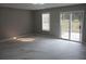 Spacious living room featuring modern tile flooring, natural light, and access to the backyard at 2775 Emerald Springs Dr, Lawrenceville, GA 30045