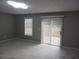 Large living room with sliding doors and window providing natural light and backyard views at 2775 Emerald Springs Dr, Lawrenceville, GA 30045