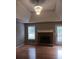 Cozy living room features hardwood floors, a brick fireplace, and natural lighting at 2775 Emerald Springs Dr, Lawrenceville, GA 30045