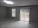 Bright living room with marble floors, large window, and sliding glass doors at 2775 Emerald Springs Dr, Lawrenceville, GA 30045