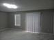 Neutral living room with bright lighting and sliding glass door with backyard access at 2775 Emerald Springs Dr, Lawrenceville, GA 30045