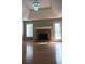 Spacious living room with hardwood floors, brick fireplace, and a large window at 2775 Emerald Springs Dr, Lawrenceville, GA 30045