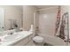 Well-lit bathroom with a shower-tub combo, vanity with sink, and neutral-colored walls at 3829 Thayer Trce, Duluth, GA 30096