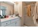 Bathroom features a shower and a white vanity with drawers and a mirror at 3829 Thayer Trce, Duluth, GA 30096