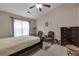 Bedroom featuring vaulted ceilings, a ceiling fan, a queen bed frame, dresser, and two chairs at 3829 Thayer Trce, Duluth, GA 30096