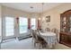 Bright dining area with a chandelier, access to the yard, and a large cabinet for storage at 3829 Thayer Trce, Duluth, GA 30096