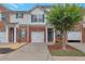 Charming townhome with a brick facade, white trim, a one-car garage, and a well-maintained front yard at 3829 Thayer Trce, Duluth, GA 30096