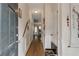 Inviting hallway featuring hardwood floors, white wainscoting, neutral paint, and decorative wall accents at 3829 Thayer Trce, Duluth, GA 30096