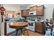 Functional kitchen with wooden cabinets, white appliances, and a center island with seating at 3829 Thayer Trce, Duluth, GA 30096