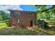 Backyard features a brick home with an upper and lower window, and a dark colored back door at 766 Virginia Cir, Forest Park, GA 30297