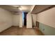 Unfinished basement room with concrete floor, partially finished walls, and air conditioning unit at 766 Virginia Cir, Forest Park, GA 30297