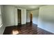 Bedroom with hardwood floors, large closet, and a doorway to another room at 766 Virginia Cir, Forest Park, GA 30297