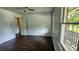 Bedroom with hardwood floors and natural light from the windows overlooking the yard at 766 Virginia Cir, Forest Park, GA 30297