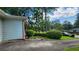Charming one-story home featuring lush, mature landscaping and an expansive driveway at 766 Virginia Cir, Forest Park, GA 30297