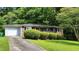 Single-story brick home featuring an attached garage and mature landscaping at 766 Virginia Cir, Forest Park, GA 30297