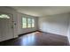 Bright living room features gleaming hardwood floors and ample natural light at 766 Virginia Cir, Forest Park, GA 30297