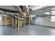 Unfinished basement with visible duct work, painted concrete floor, hot water tank and utility sink at 256 Indian Trl, Marietta, GA 30068