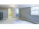 Finished basement with carpet, a window, and an open doorway to another room at 256 Indian Trl, Marietta, GA 30068