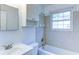 Bright bathroom with tiled shower and tub, plus a white vanity and mirror at 256 Indian Trl, Marietta, GA 30068