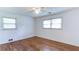 Empty bedroom featuring hardwood floors, ceiling fan and two bright, sunny windows at 256 Indian Trl, Marietta, GA 30068