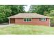 Charming brick home featuring manicured lawn, windows and mature trees at 256 Indian Trl, Marietta, GA 30068