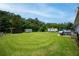 Vast backyard offers abundant space for outdoor enjoyment, featuring a shed, trailers, and mature trees at 27 Ansley Nw Way, Cartersville, GA 30121