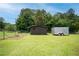 Expansive backyard features a shed, trailer, and garden area, providing ample space for storage and gardening at 27 Ansley Nw Way, Cartersville, GA 30121
