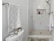 Elegant bathroom shower with marble tile, pebble flooring, and recessed shelving offers a luxurious experience at 27 Ansley Nw Way, Cartersville, GA 30121