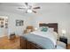 Comfortable bedroom featuring hardwood floors, a ceiling fan, and a cozy reading chair at 27 Ansley Nw Way, Cartersville, GA 30121