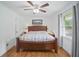 Cozy bedroom featuring hardwood floors, a ceiling fan, and a large window at 27 Ansley Nw Way, Cartersville, GA 30121