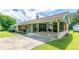 View of the attached carport with brick columns, a well-maintained driveway, and a cozy front porch at 27 Ansley Nw Way, Cartersville, GA 30121