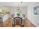 Bright dining room with seating for eight and a modern chandelier at 27 Ansley Nw Way, Cartersville, GA 30121