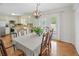 Dining room featuring a large table, stylish light fixture, and access to the kitchen at 27 Ansley Nw Way, Cartersville, GA 30121