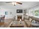 Open-concept living room and dining area with fireplace and plenty of natural light at 27 Ansley Nw Way, Cartersville, GA 30121