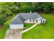 Aerial view of the property featuring a well maintained lawn and driveway at 6328 Wellington Ct, Douglasville, GA 30134