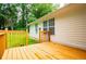 View of the wooden back porch, home exterior, and green yard at 6328 Wellington Ct, Douglasville, GA 30134
