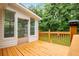 View of the back porch with a wooden railing, siding, and green backyard at 6328 Wellington Ct, Douglasville, GA 30134