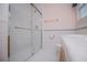 Bathroom featuring a tiled shower with glass doors and a toilet with a wooden vanity at 6328 Wellington Ct, Douglasville, GA 30134