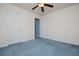 Neutral bedroom featuring blue carpet and two doors at 6328 Wellington Ct, Douglasville, GA 30134