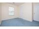 Bedroom featuring a window, blue carpet and neutral walls at 6328 Wellington Ct, Douglasville, GA 30134