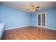 Bedroom with french doors, blue walls and hardwood flooring at 6328 Wellington Ct, Douglasville, GA 30134