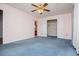 Spacious bedroom with a ceiling fan, neutral walls and blue carpet at 6328 Wellington Ct, Douglasville, GA 30134