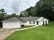Charming single-story home featuring a well-manicured lawn and an attached two-car garage at 6328 Wellington Ct, Douglasville, GA 30134