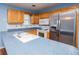 Functional kitchen with stainless steel appliances, blue countertops and ample cabinet space at 6328 Wellington Ct, Douglasville, GA 30134