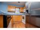 Traditional kitchen featuring wood cabinets, modern appliances and hardwood flooring at 6328 Wellington Ct, Douglasville, GA 30134