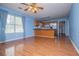 Open concept living area features wood flooring and view of the kitchen at 6328 Wellington Ct, Douglasville, GA 30134