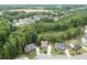 Scenic aerial shot of a residential area showing home nestled among mature trees at 7070 Concord Mountain Trl, Cumming, GA 30028