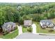 Aerial view of home nestled among mature trees in a desirable neighborhood at 7070 Concord Mountain Trl, Cumming, GA 30028
